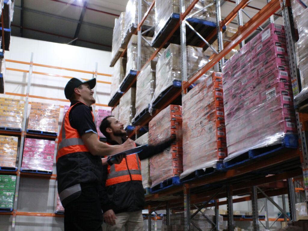 Staffs are monitoring chocolate pallets in temperature-controlled cold storage facility