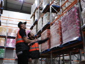 Staffs are monitoring chocolate pallets in temperature-controlled cold storage facility