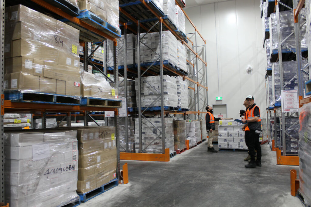 Warehouse staff handling ready meals in temperature-controlled cold storage