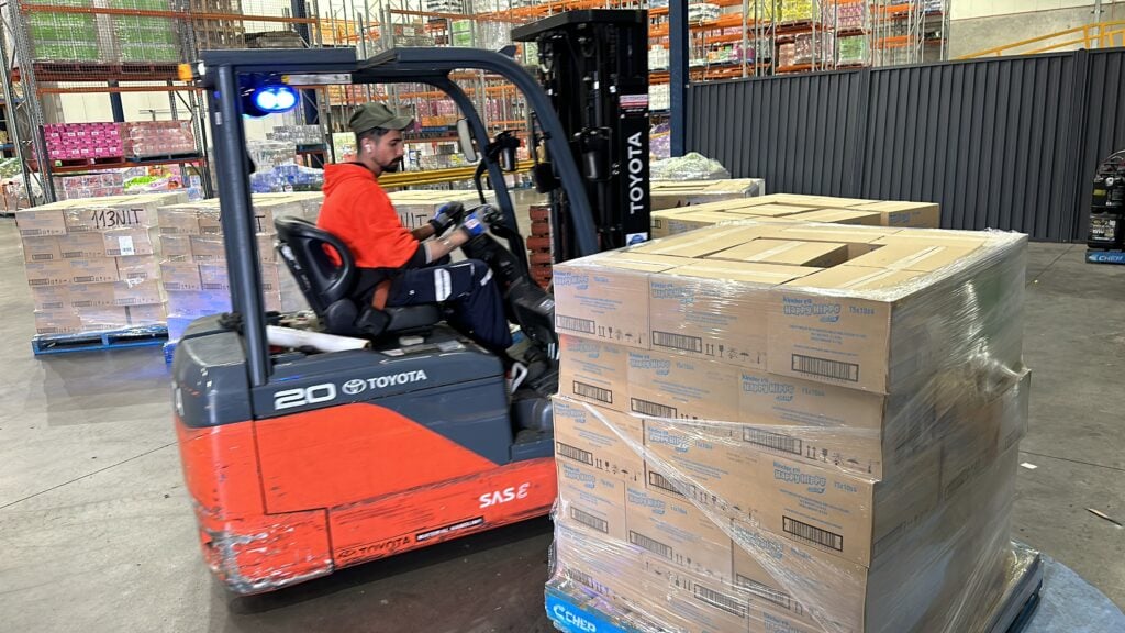 Refrigerated transport truck being loaded with palletised goods in cold chain fleet