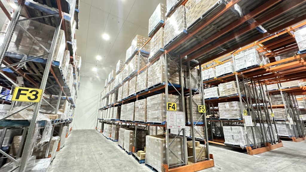 Cold storage warehouse aisle with stacked frozen pallets